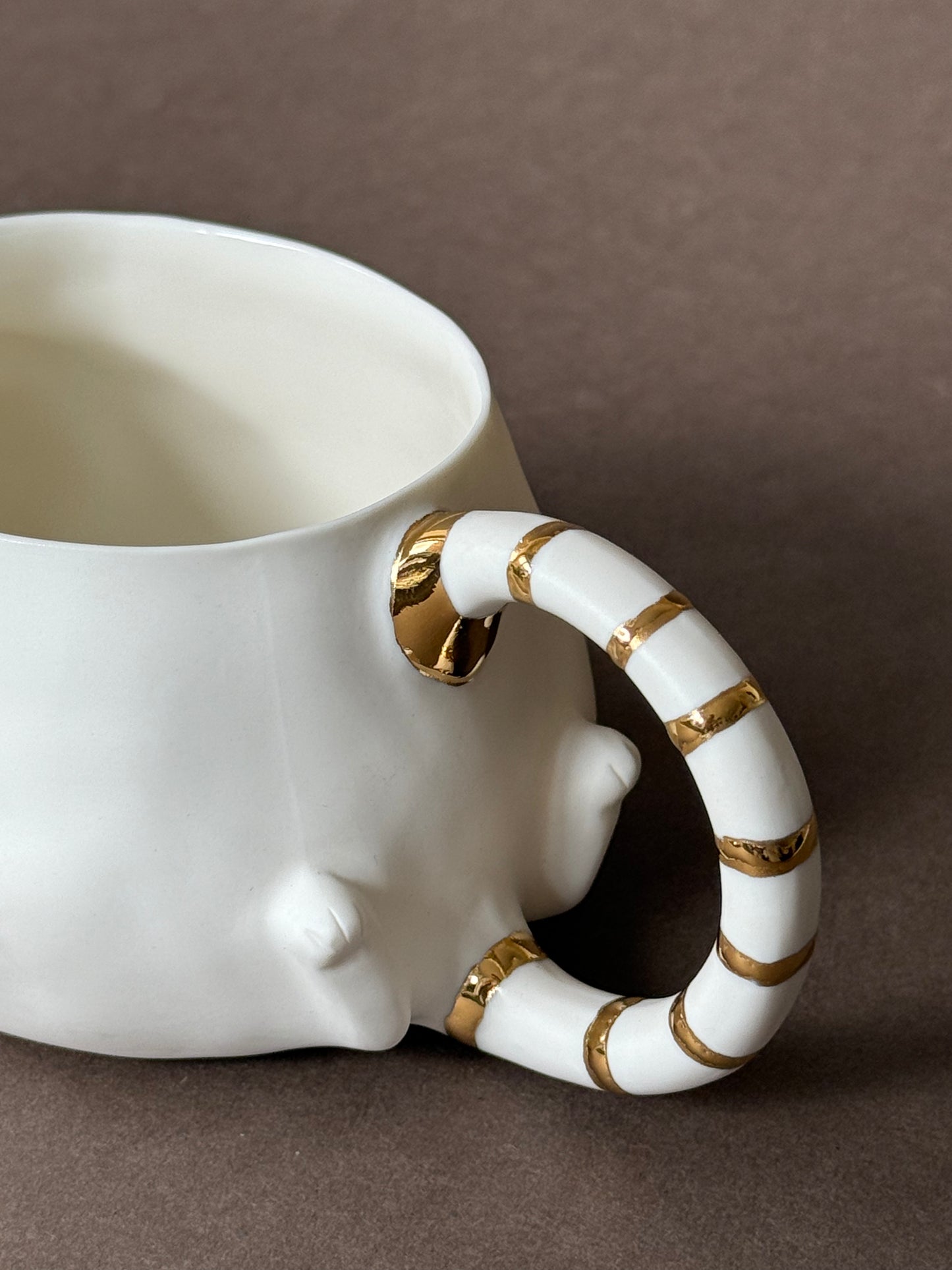 Porcelain Cat with gold striped tail