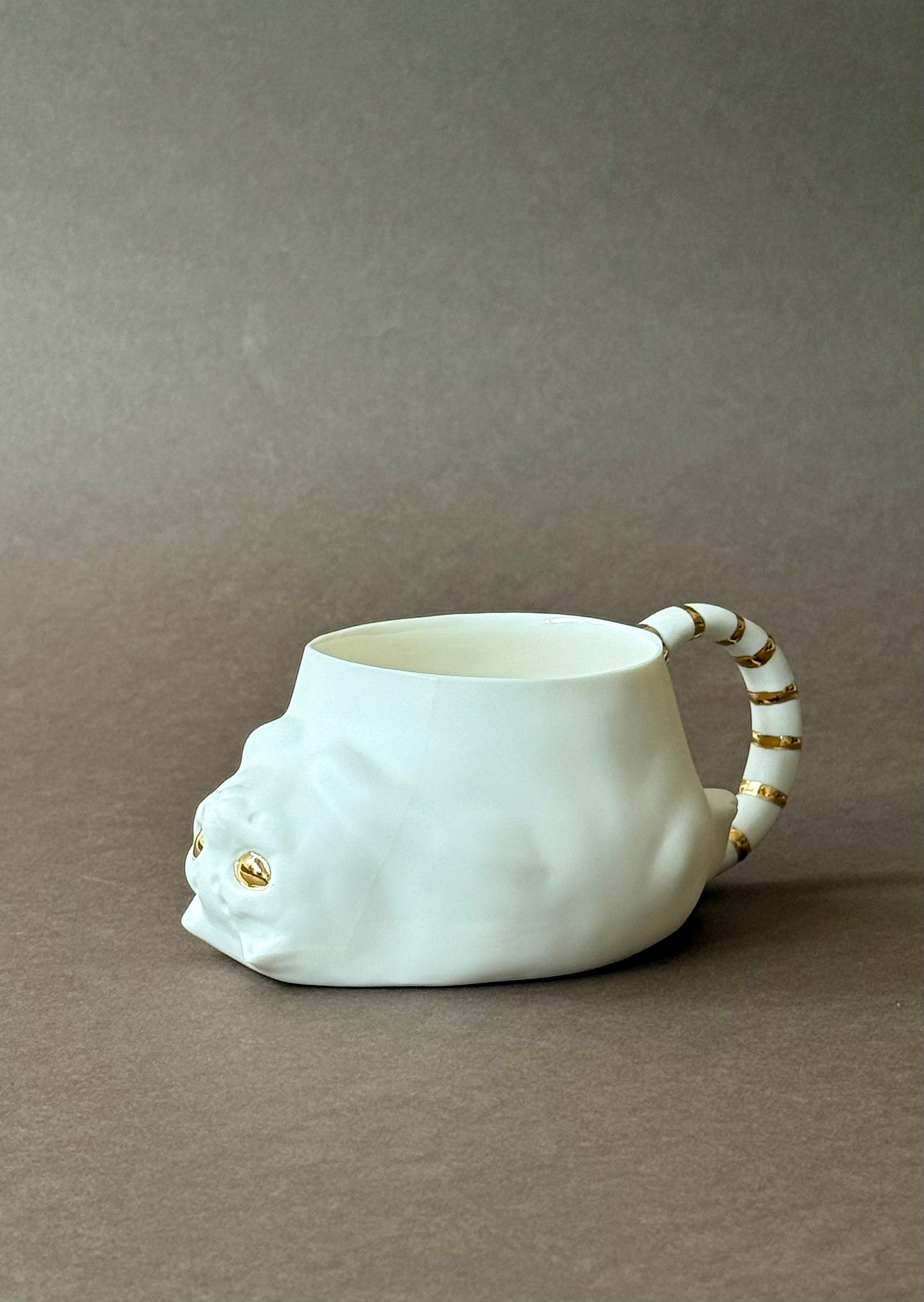Porcelain Cat with gold striped tail