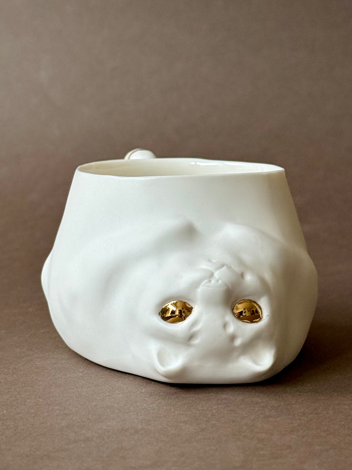 Porcelain Cat with gold striped tail