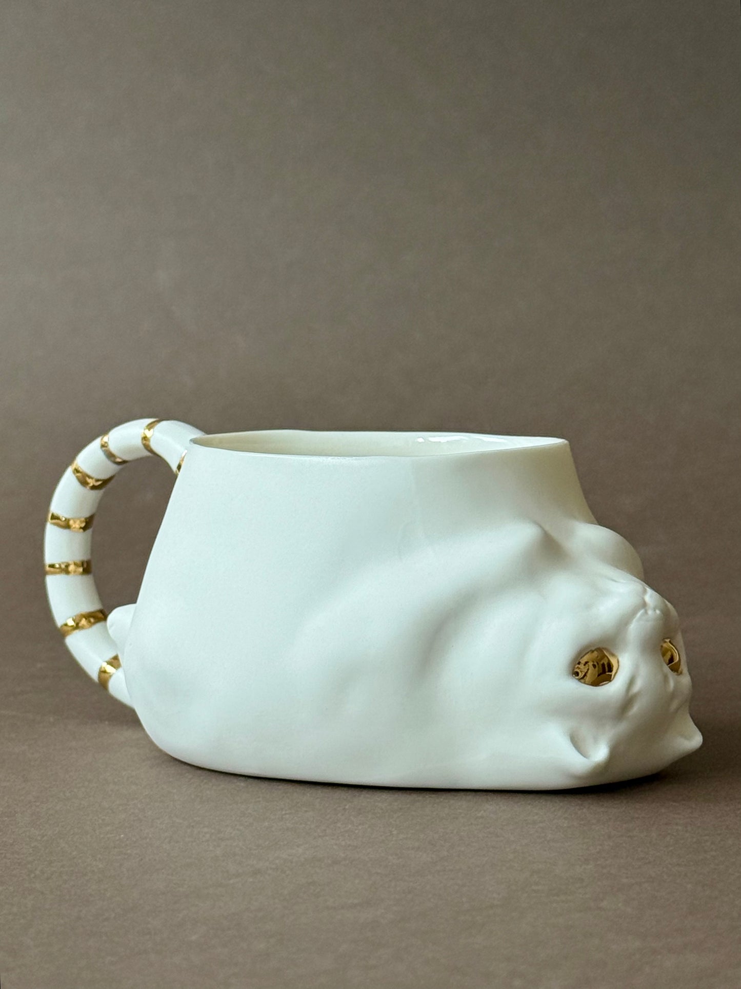 Porcelain Cat with gold striped tail