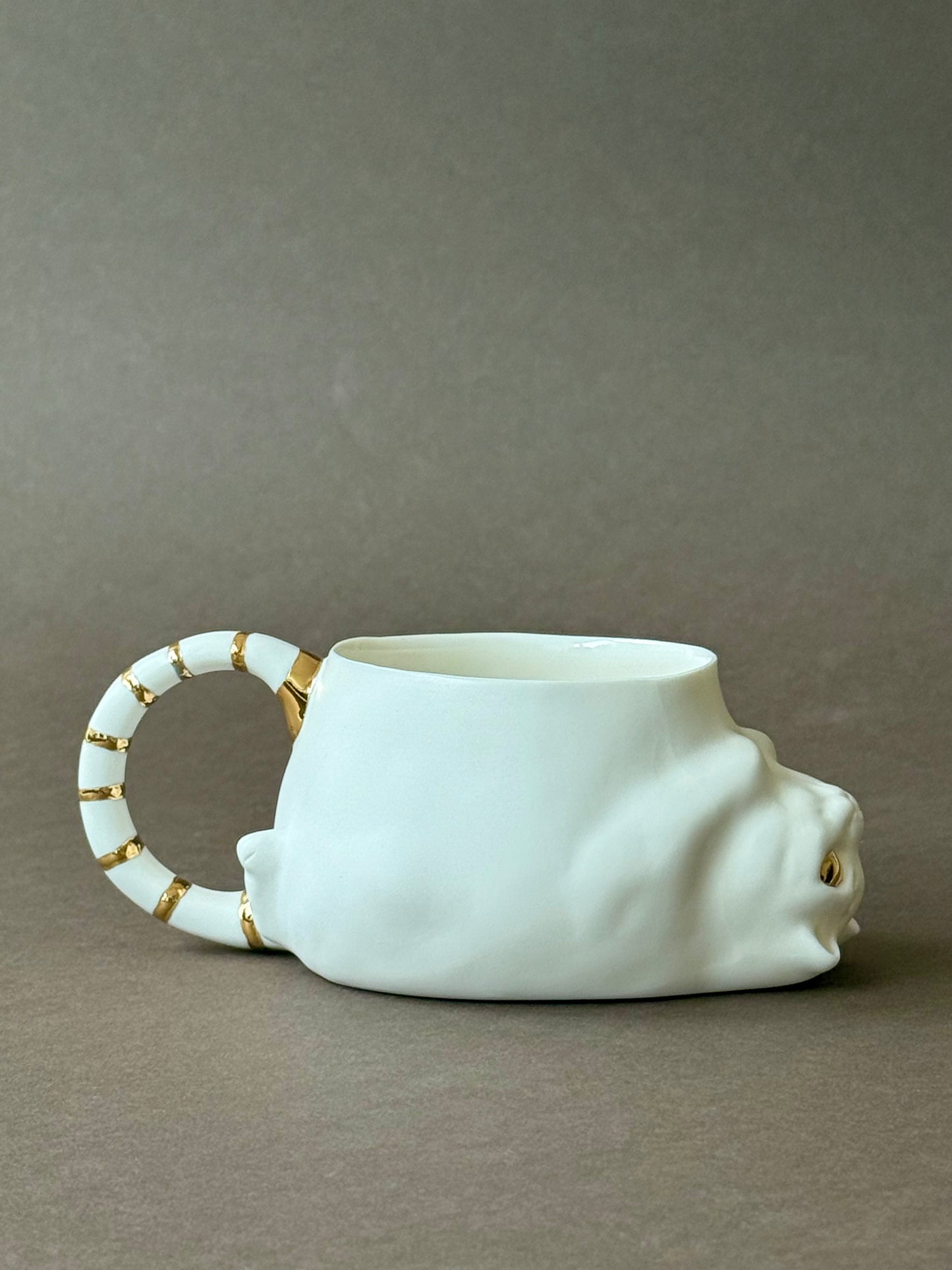 Porcelain Cat with gold striped tail