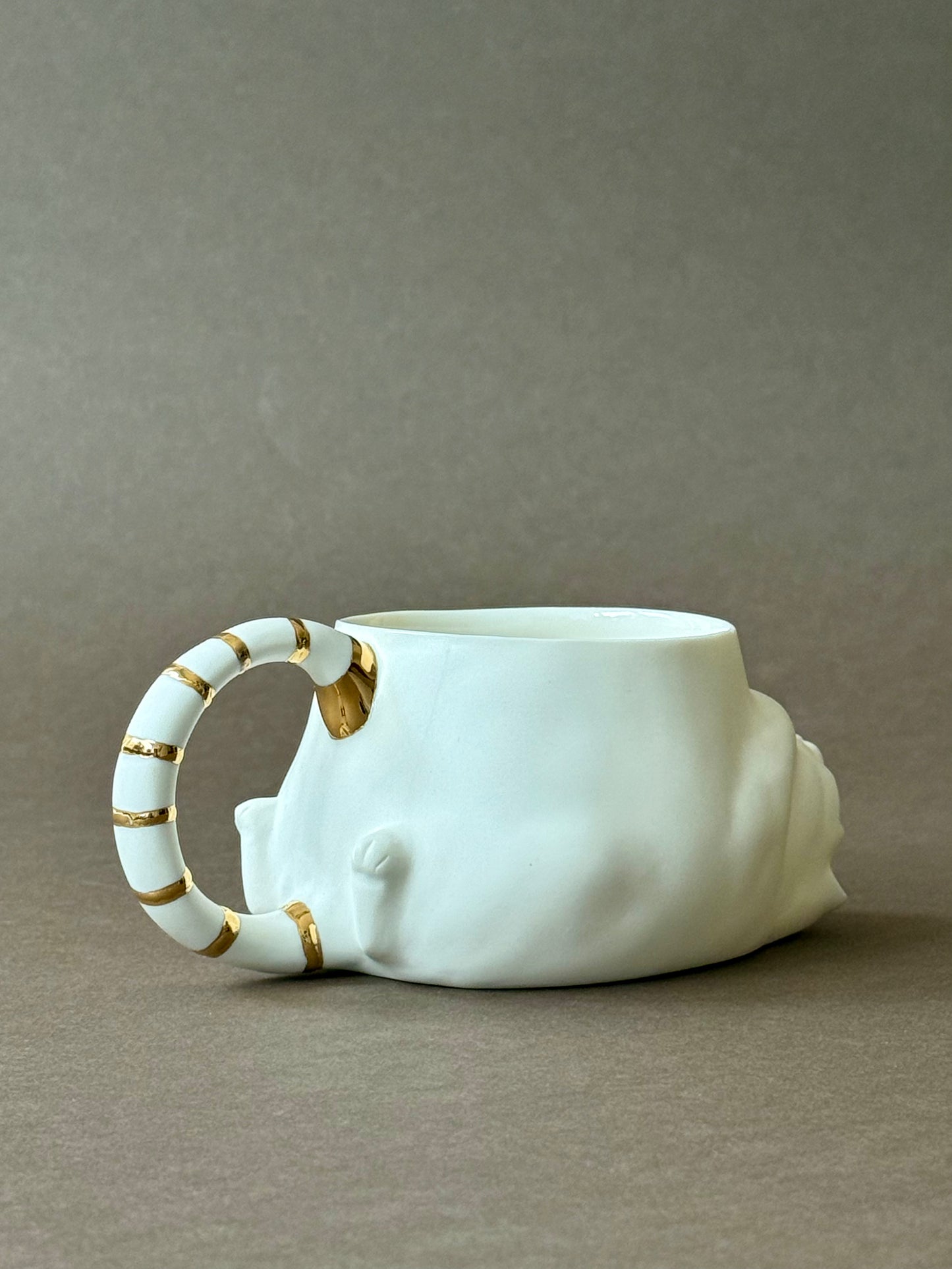 Porcelain Cat with gold striped tail