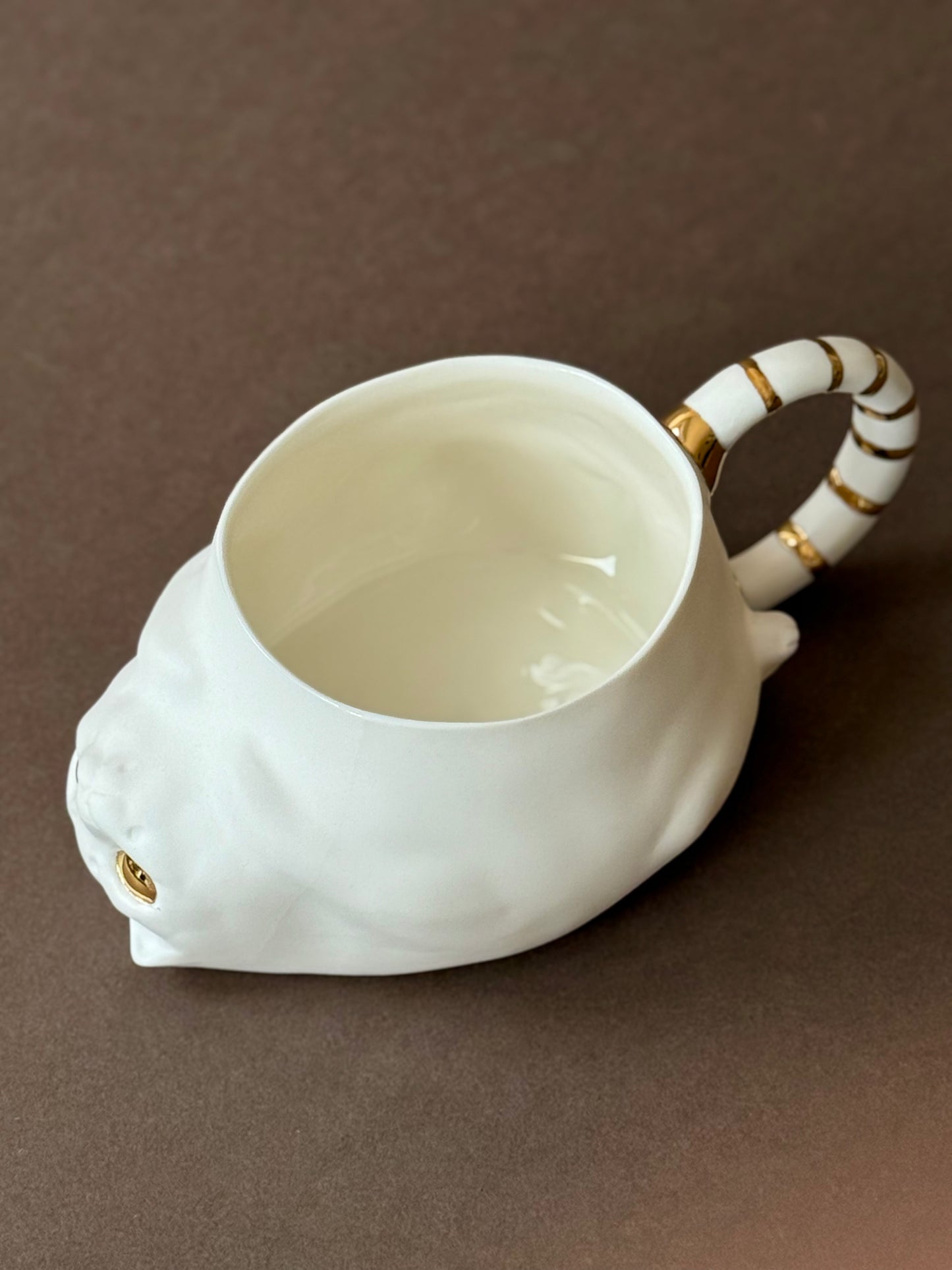 Porcelain Cat with gold striped tail